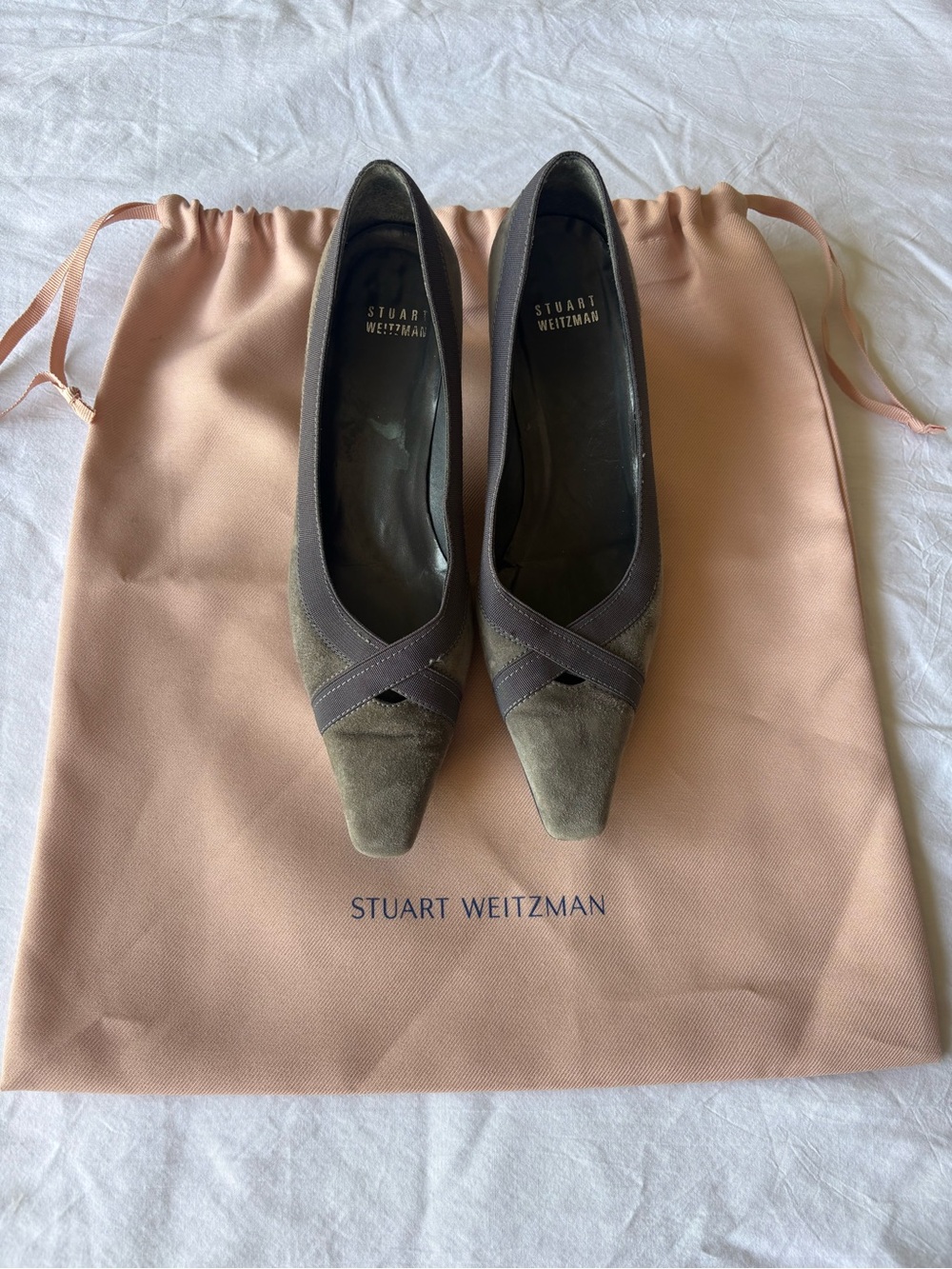 Stuart Weitzman smoky gray suede pumps with a cross-grain ribbon accent.